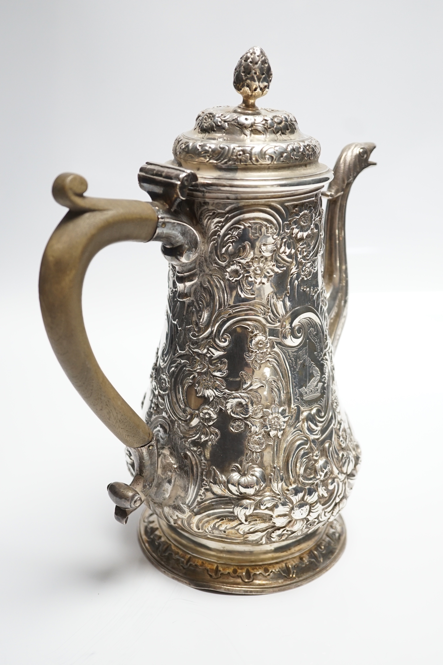 A George II silver baluster coffee pot, with later embossed decoration, maker, ?W, London, 1751, height 25.5cm, gross weight 31.3oz.